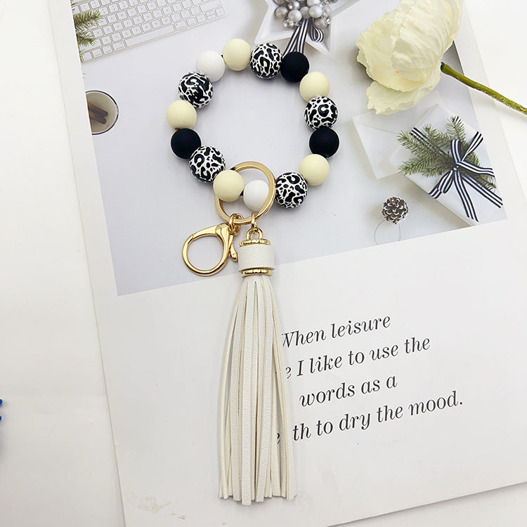 Wholesale Black leopard print wooden bead keychain with white background