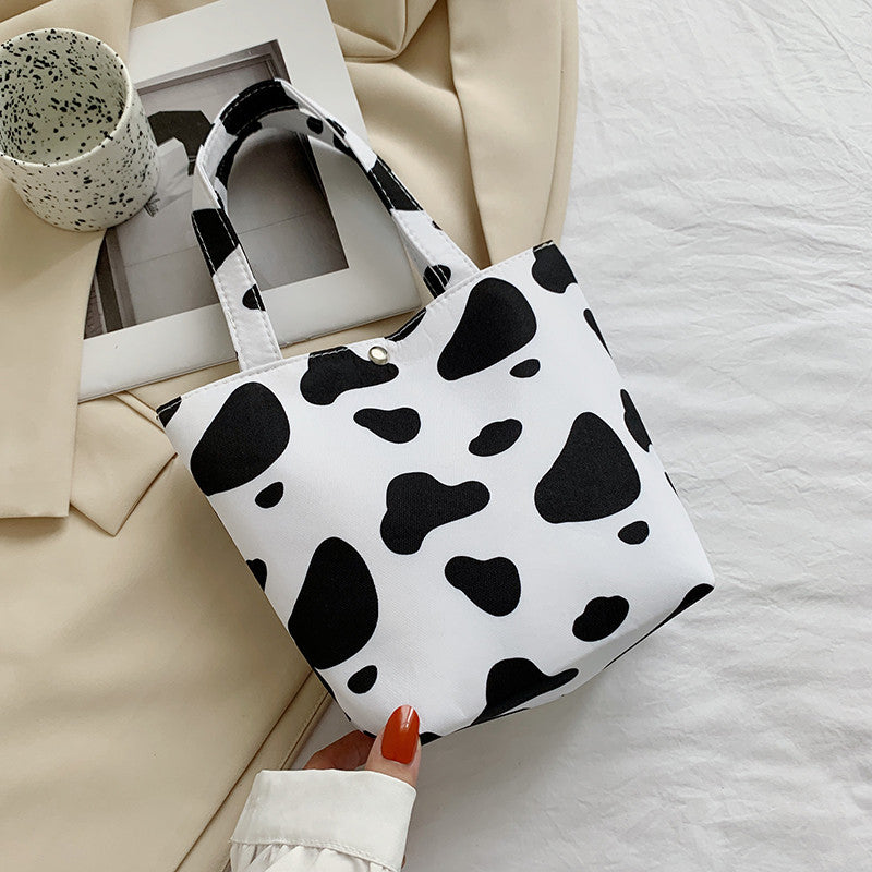 La bolsa de asas de mariposa con estampado de leopardo y estampado de vaca de poliéster al por mayor