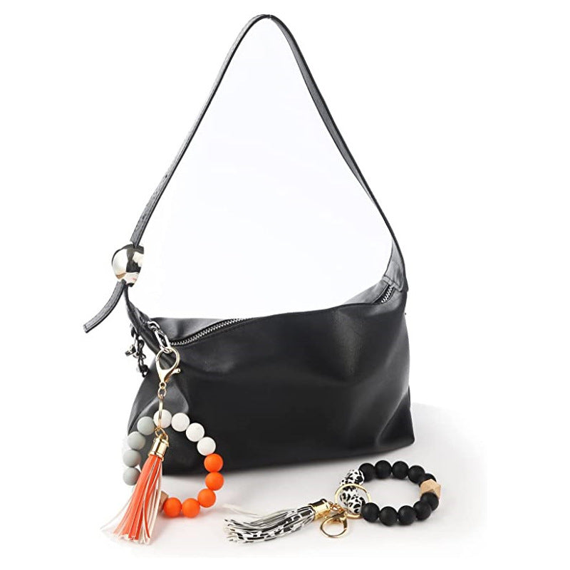 Llavero al por mayor de la muñeca de la mano de la borla del cuero del cordón del silicón del estampado de leopardo