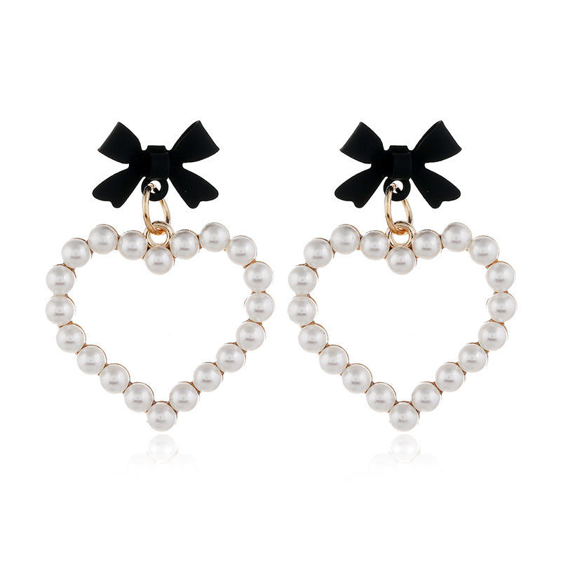 Wholesale Pearl Hollow Heart Shaped Pendant Bow Alloy Earrings