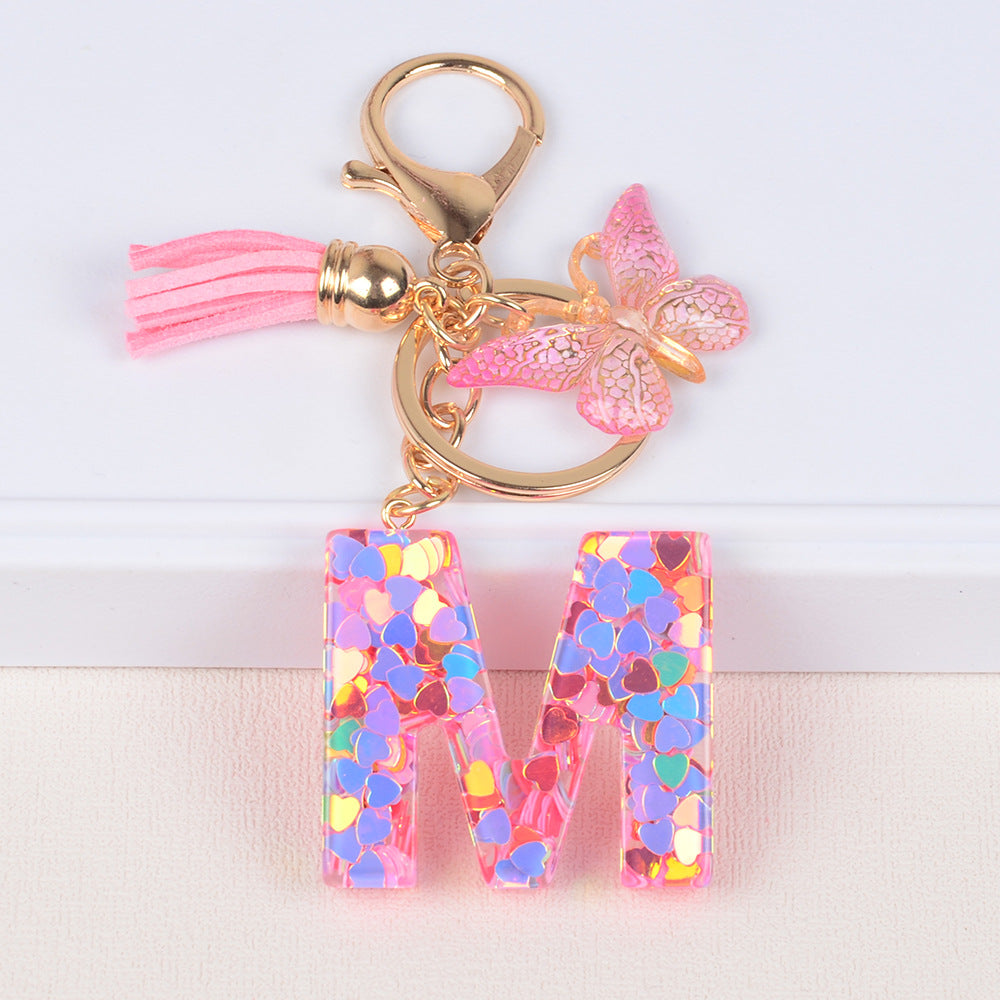 卸売ピンクタッセルバタフライグリッターレター樹脂キーホルダー