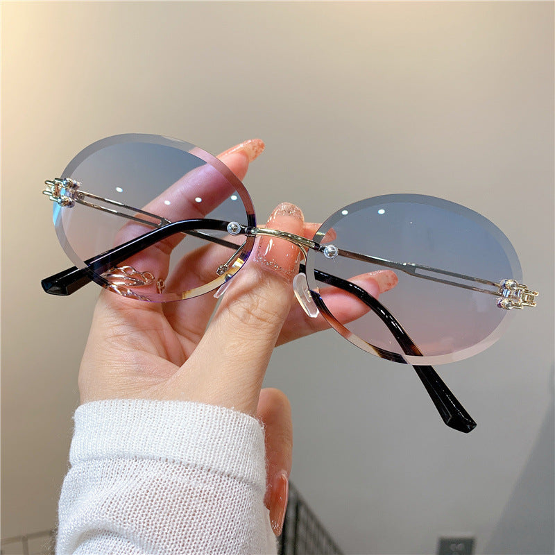 Wholesale Women's oval gradient frameless trimmed sunglasses