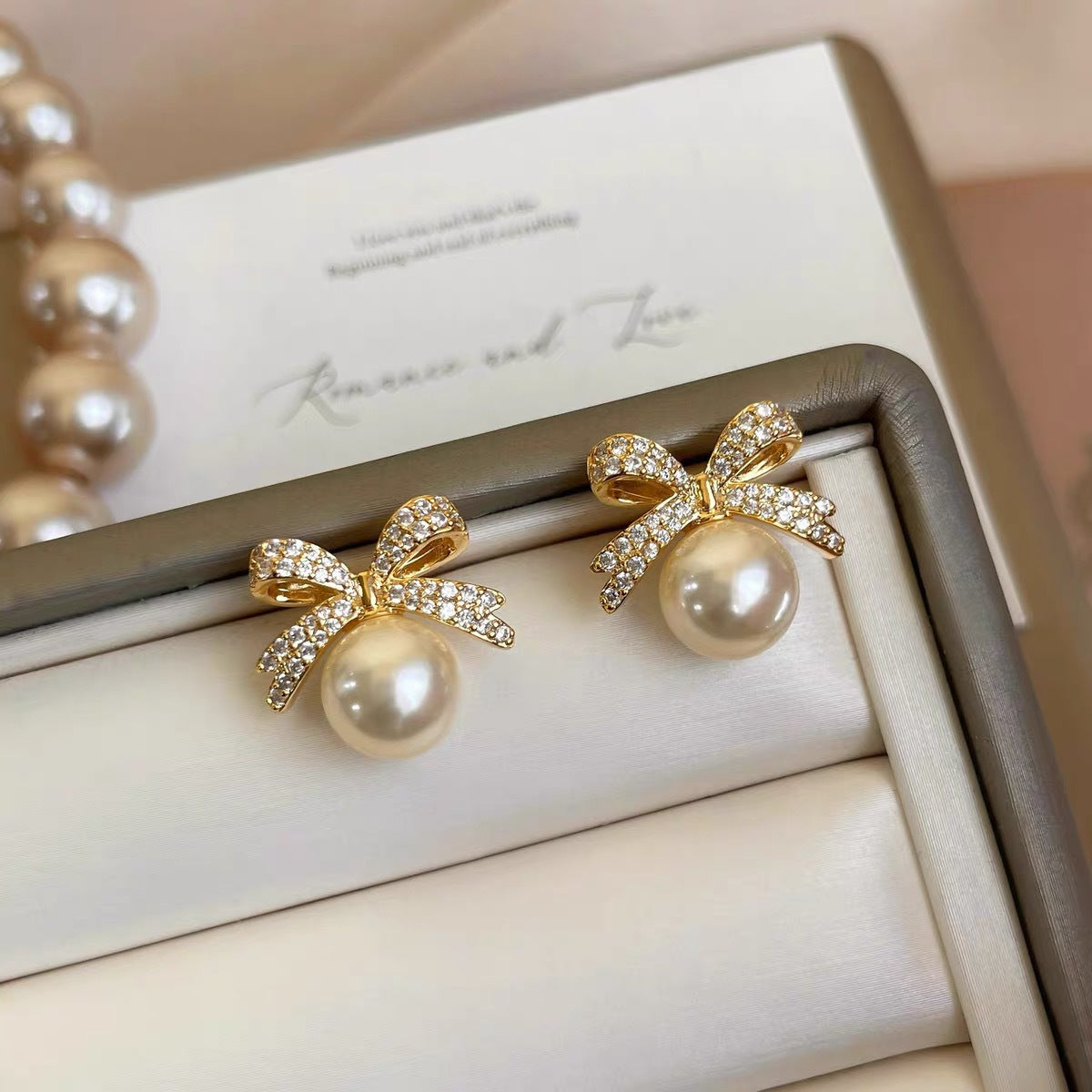 Wholesale Bow set with diamond studded pearl earrings
