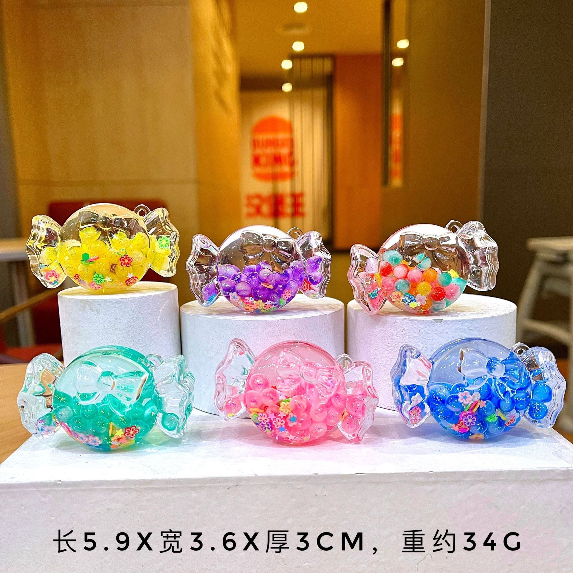 Wholesale Oil filled luminous colorful candy quicksand bottle keychain