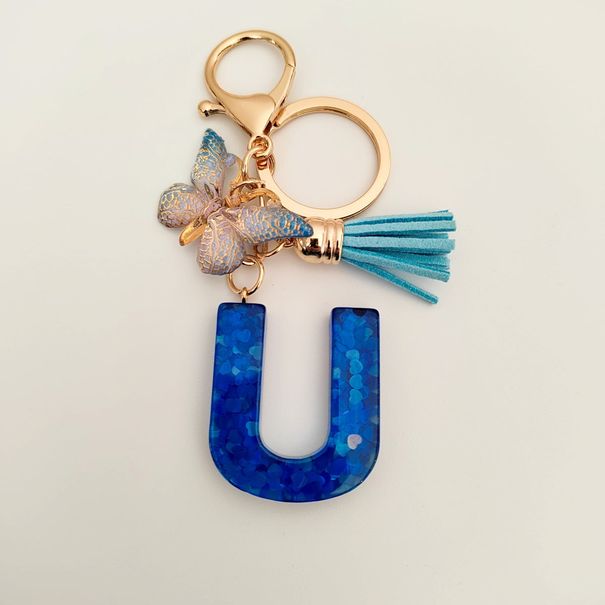 Wholesale blue crystal epoxy letter key chain pendant resin sequined butterfly key chain