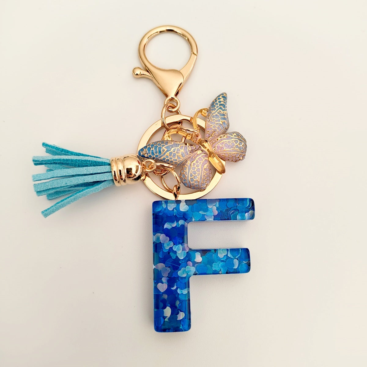 Wholesale blue crystal epoxy letter key chain pendant resin sequined butterfly key chain