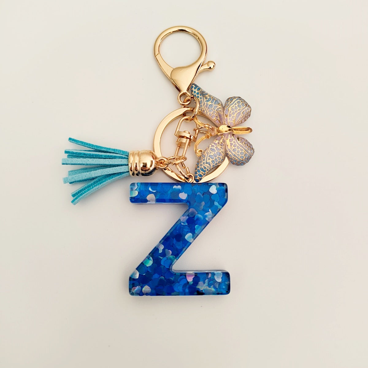 Wholesale blue crystal epoxy letter key chain pendant resin sequined butterfly key chain