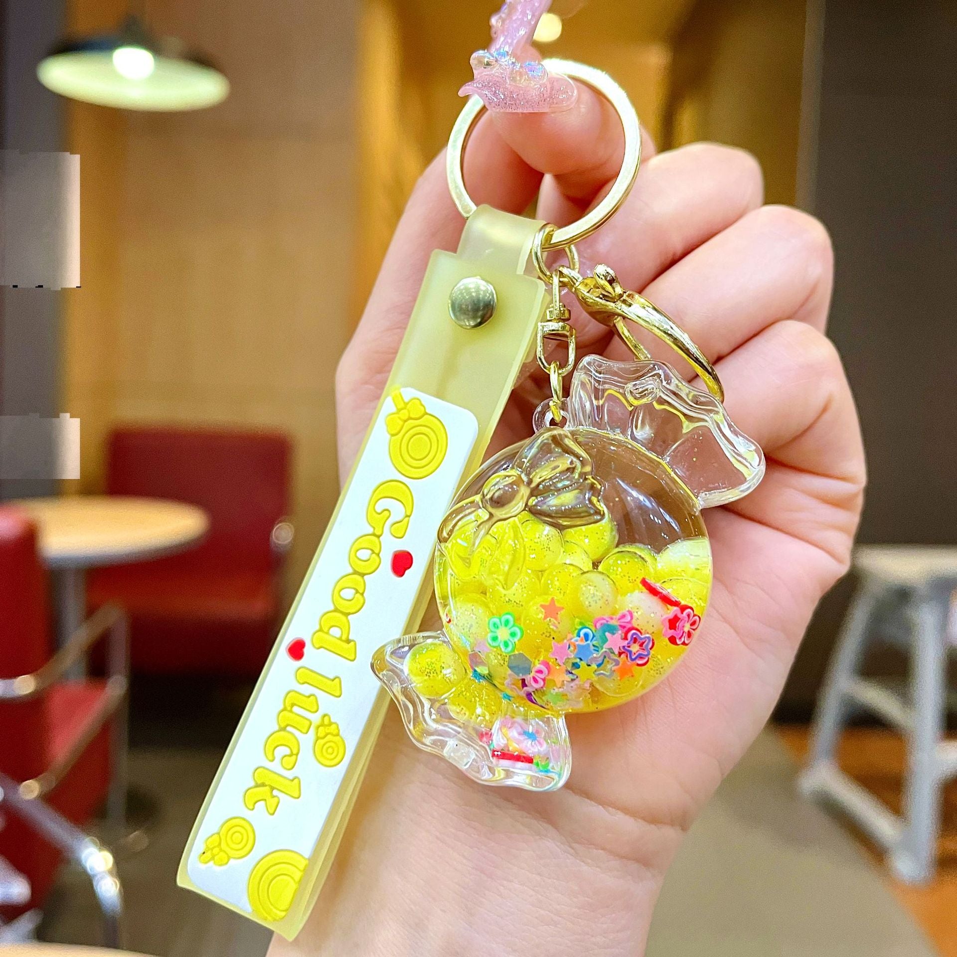 Wholesale Oil filled luminous colorful candy quicksand bottle keychain