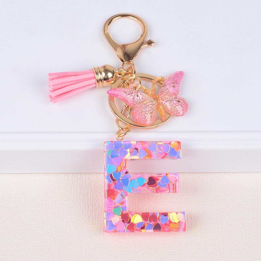 卸売ピンクタッセルバタフライグリッターレター樹脂キーホルダー