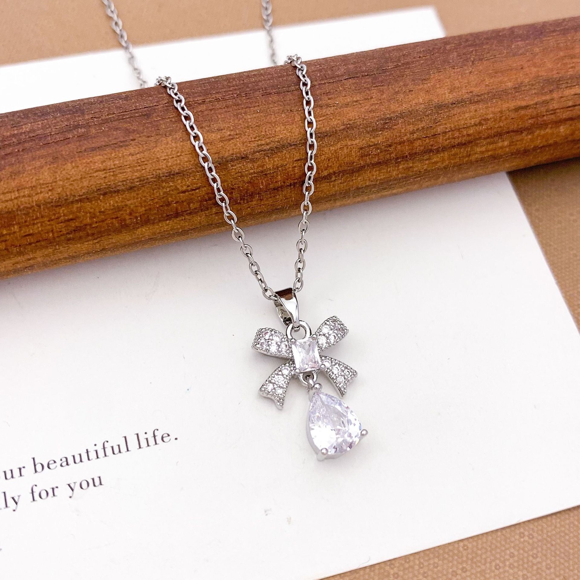 Wholesale Pink heart-shaped bow with diamond studded titanium steel necklace