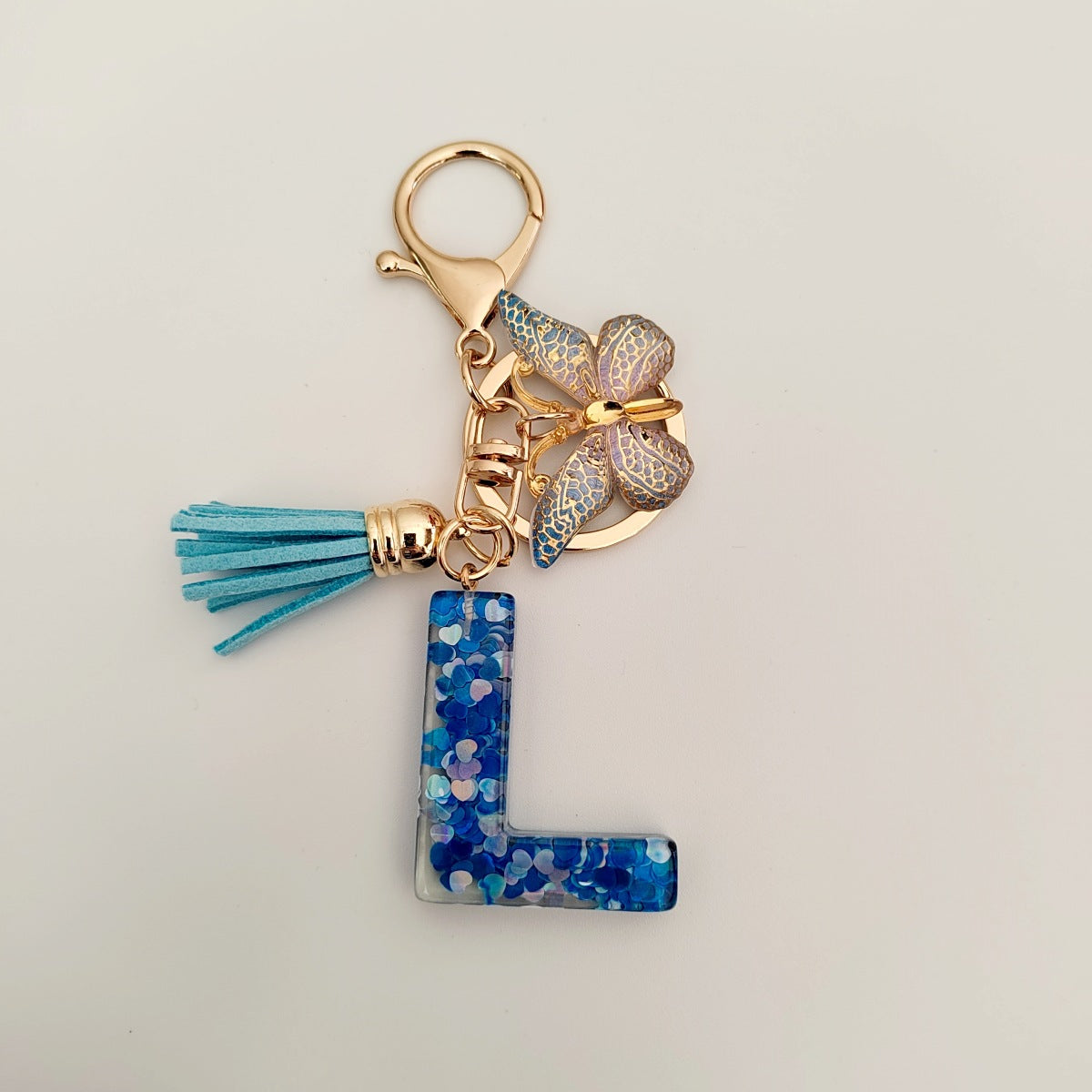 Wholesale blue crystal epoxy letter key chain pendant resin sequined butterfly key chain