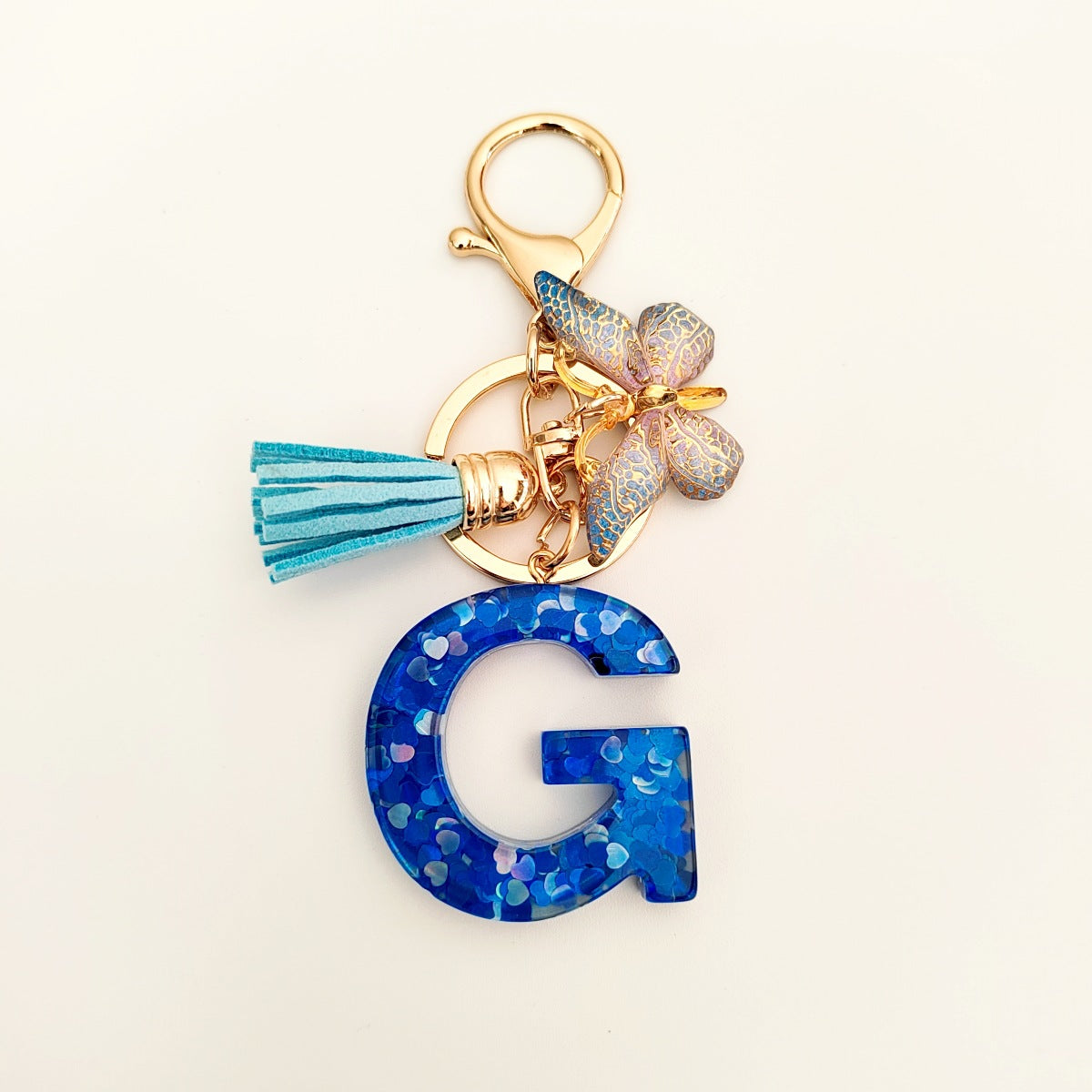 Wholesale blue crystal epoxy letter key chain pendant resin sequined butterfly key chain