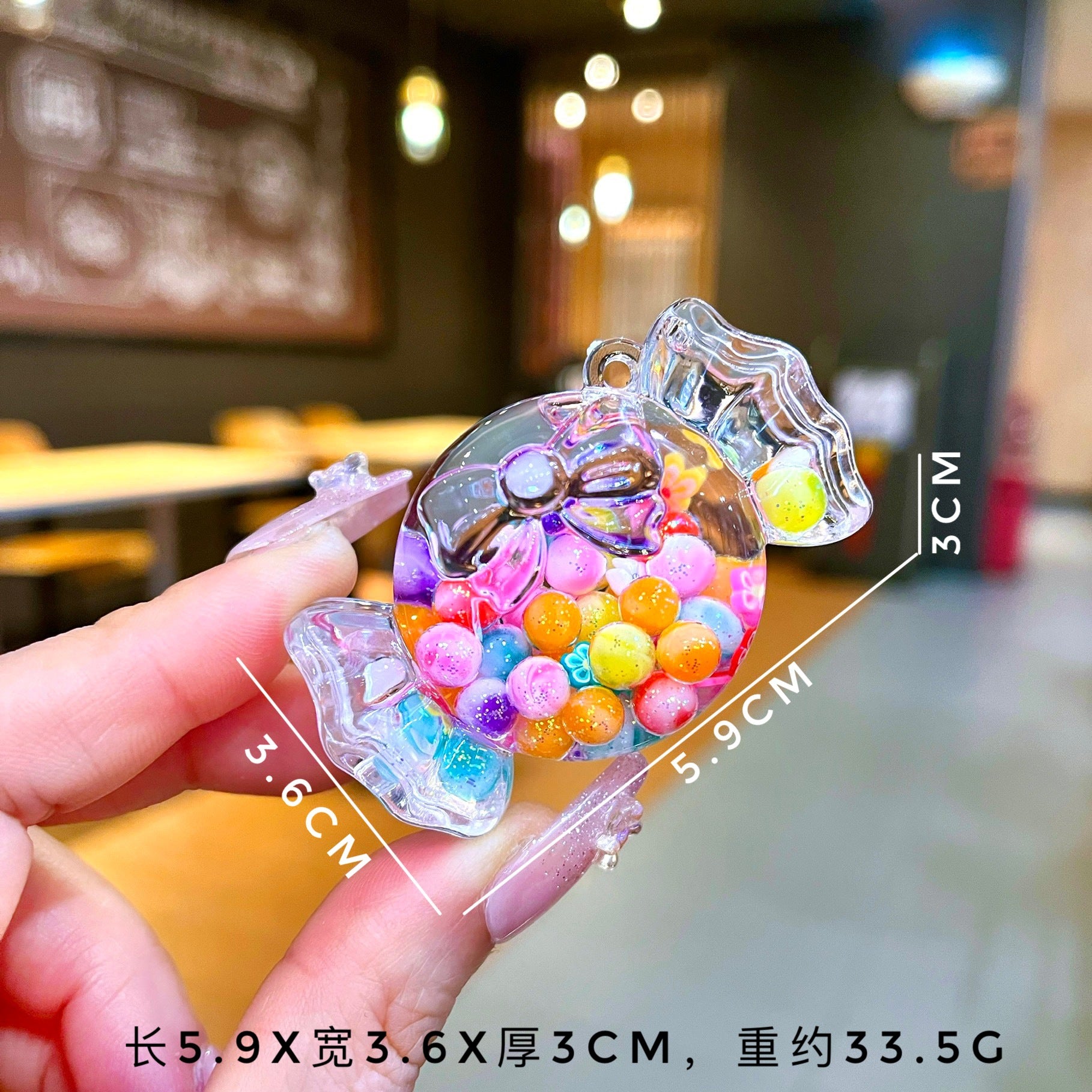 Wholesale Oil filled luminous colorful candy quicksand bottle keychain