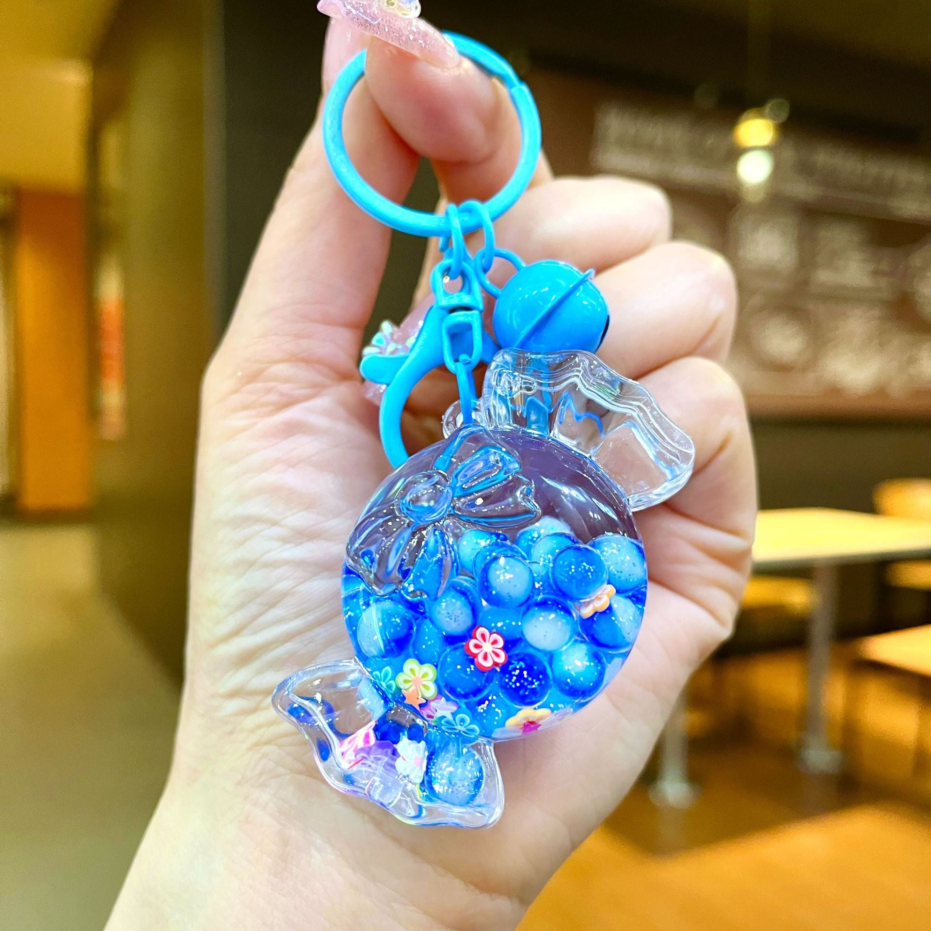 Wholesale Oil filled luminous colorful candy quicksand bottle keychain