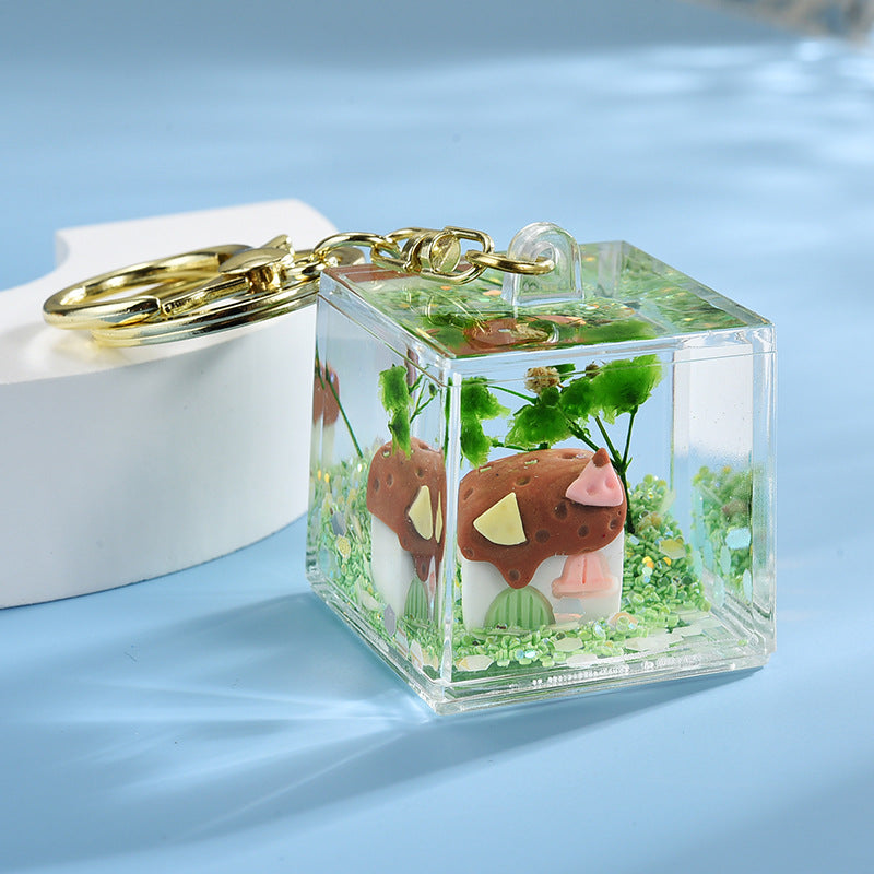 Wholesale Acrylic flowing sand in oil bottle keychain