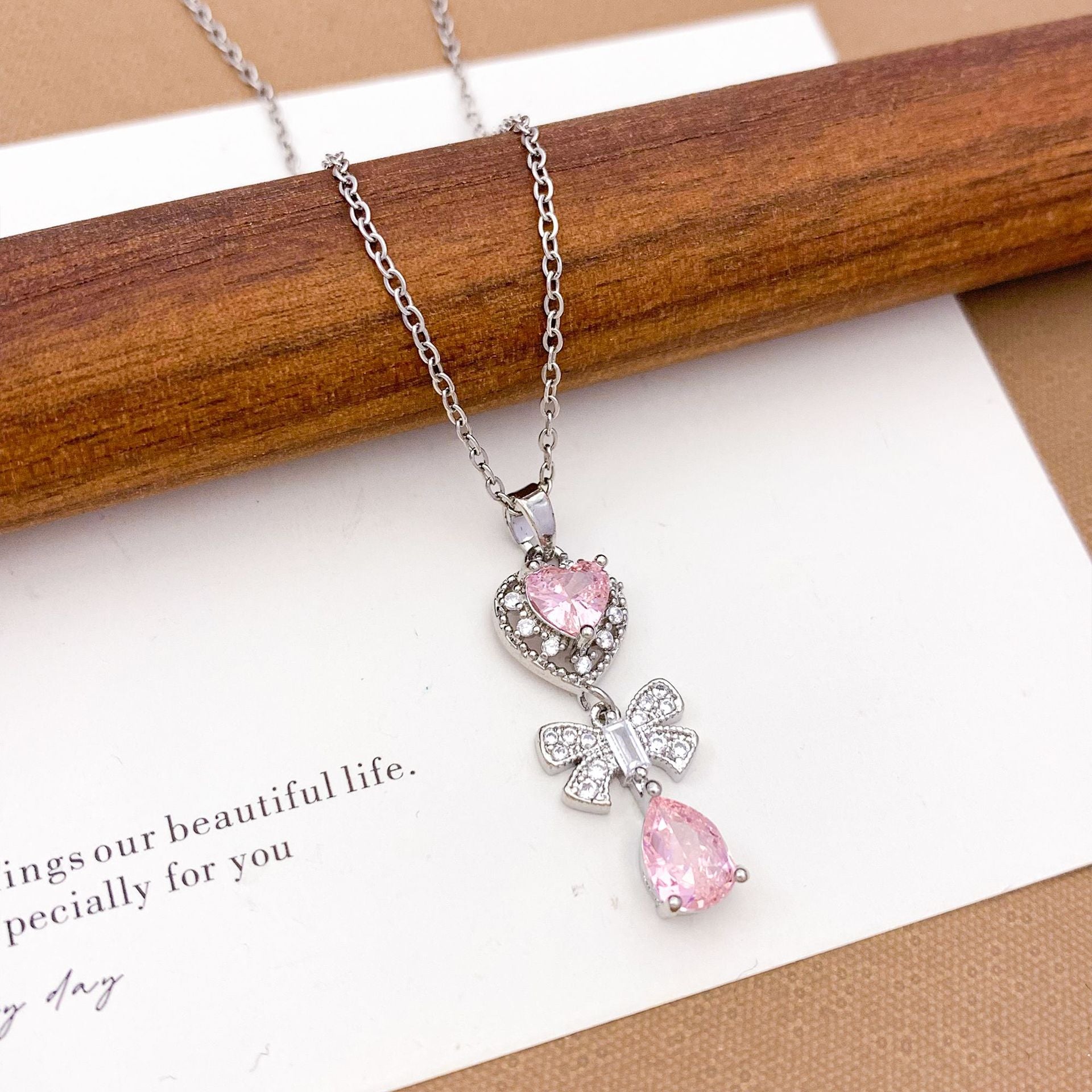 Wholesale Pink heart-shaped bow with diamond studded titanium steel necklace