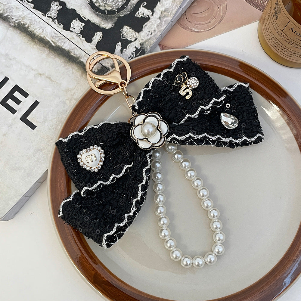 Wholesale Black and white color  style camellia pearl chain bow keychain