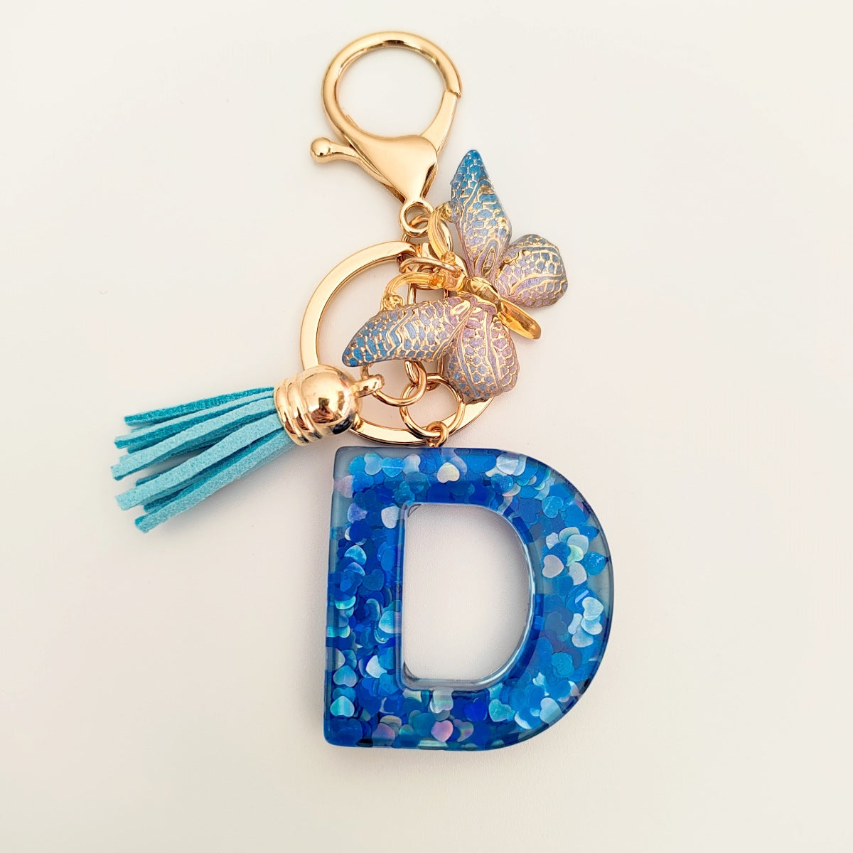 Wholesale blue crystal epoxy letter key chain pendant resin sequined butterfly key chain