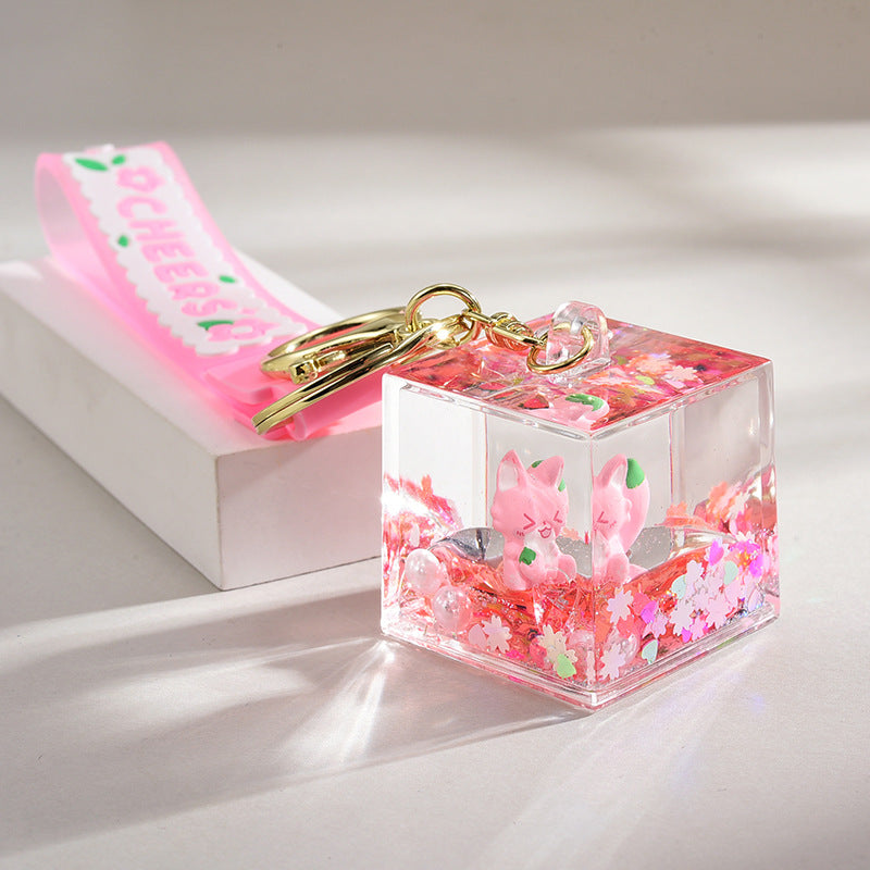 Acrílico al por mayor en la cadena de llave de botella de arena de la logística del flotador de aceite