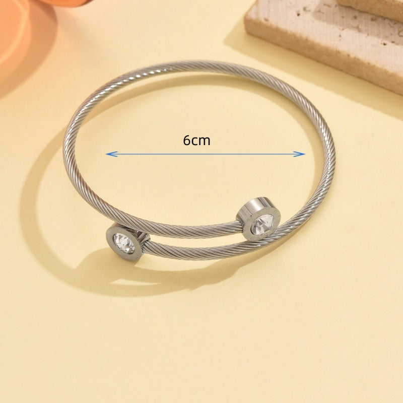 Wholesale Stainless steel artificial zircon silver open bangle with a twisted design