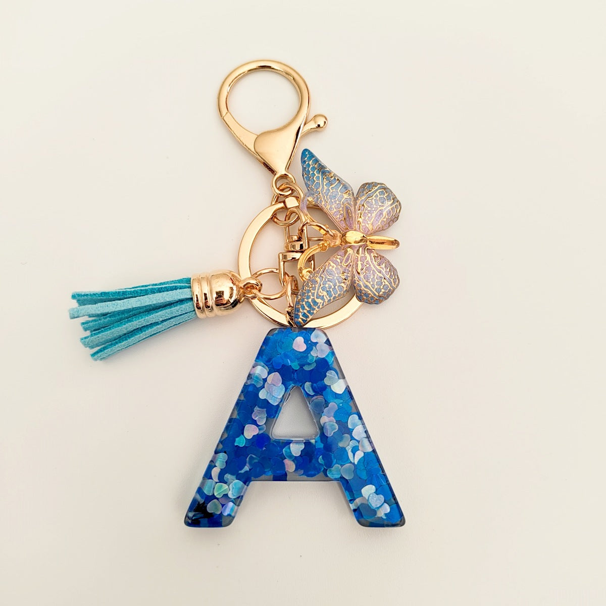 Wholesale blue crystal epoxy letter key chain pendant resin sequined butterfly key chain