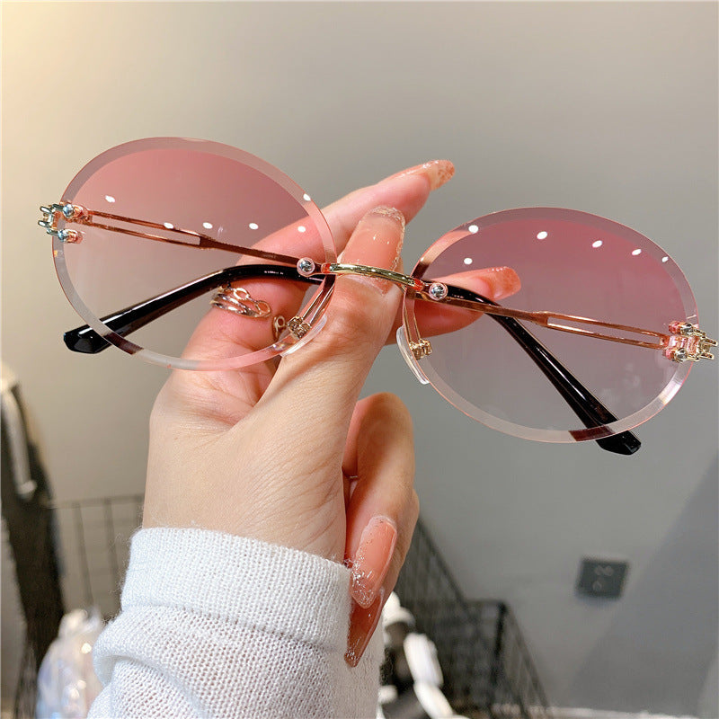 Wholesale Women's oval gradient frameless trimmed sunglasses