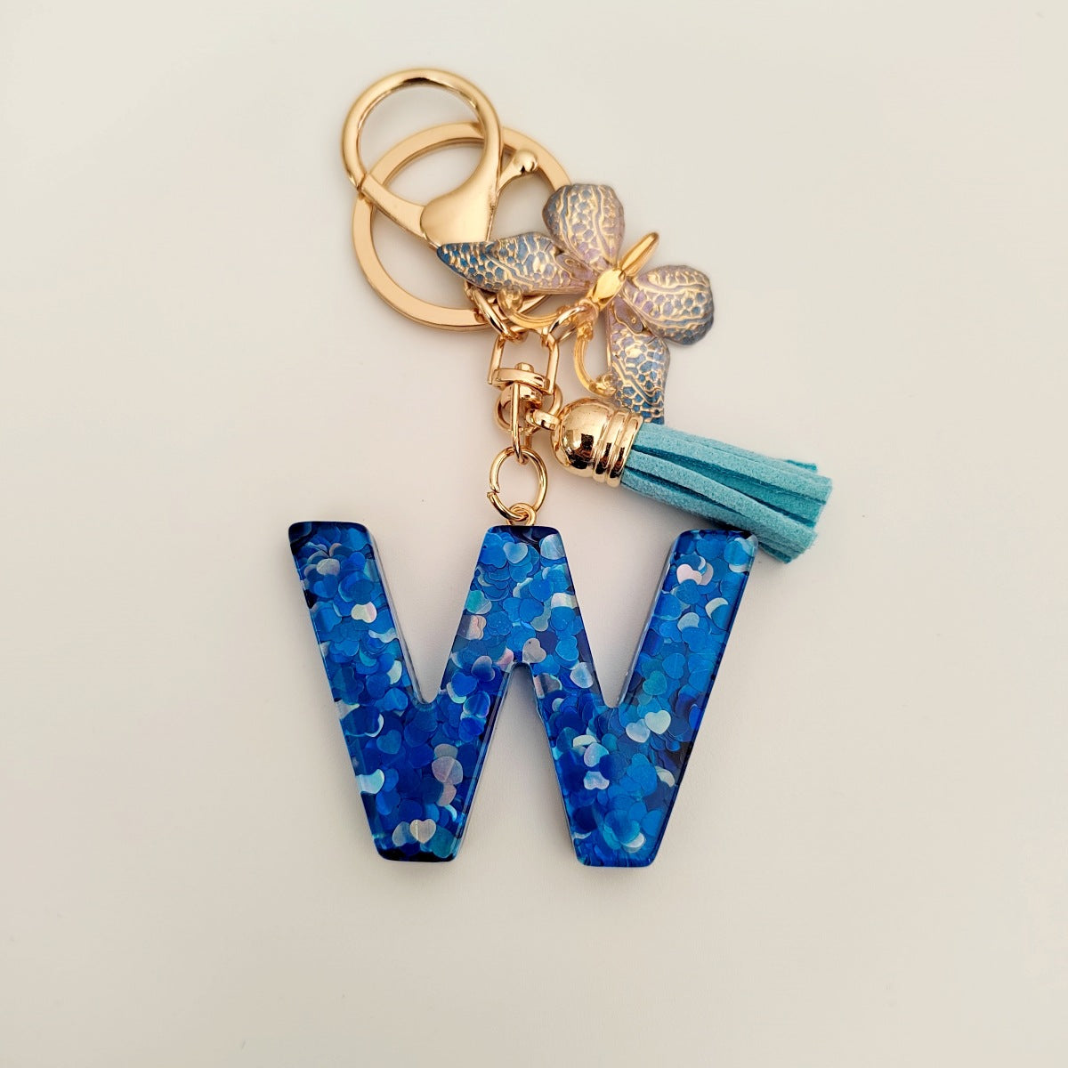 Wholesale blue crystal epoxy letter key chain pendant resin sequined butterfly key chain