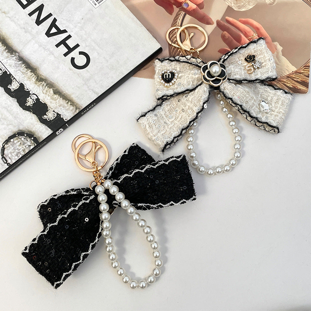 Wholesale Black and white color  style camellia pearl chain bow keychain