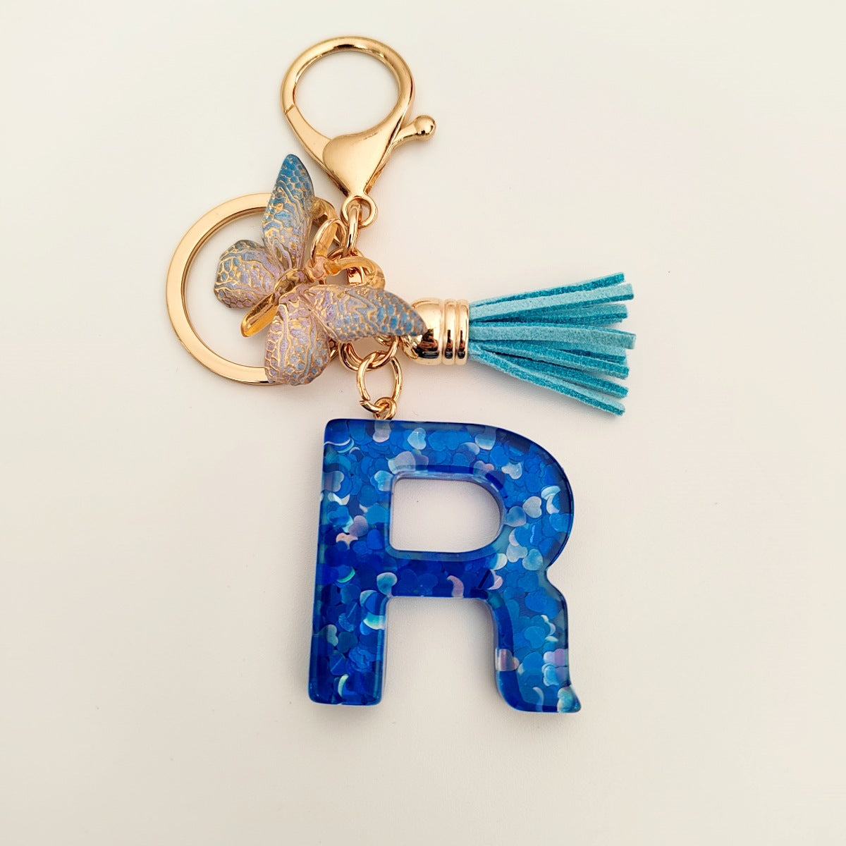 Wholesale blue crystal epoxy letter key chain pendant resin sequined butterfly key chain