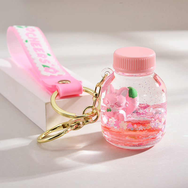 Acrílico al por mayor en la cadena de llave de botella de arena de la logística del flotador de aceite