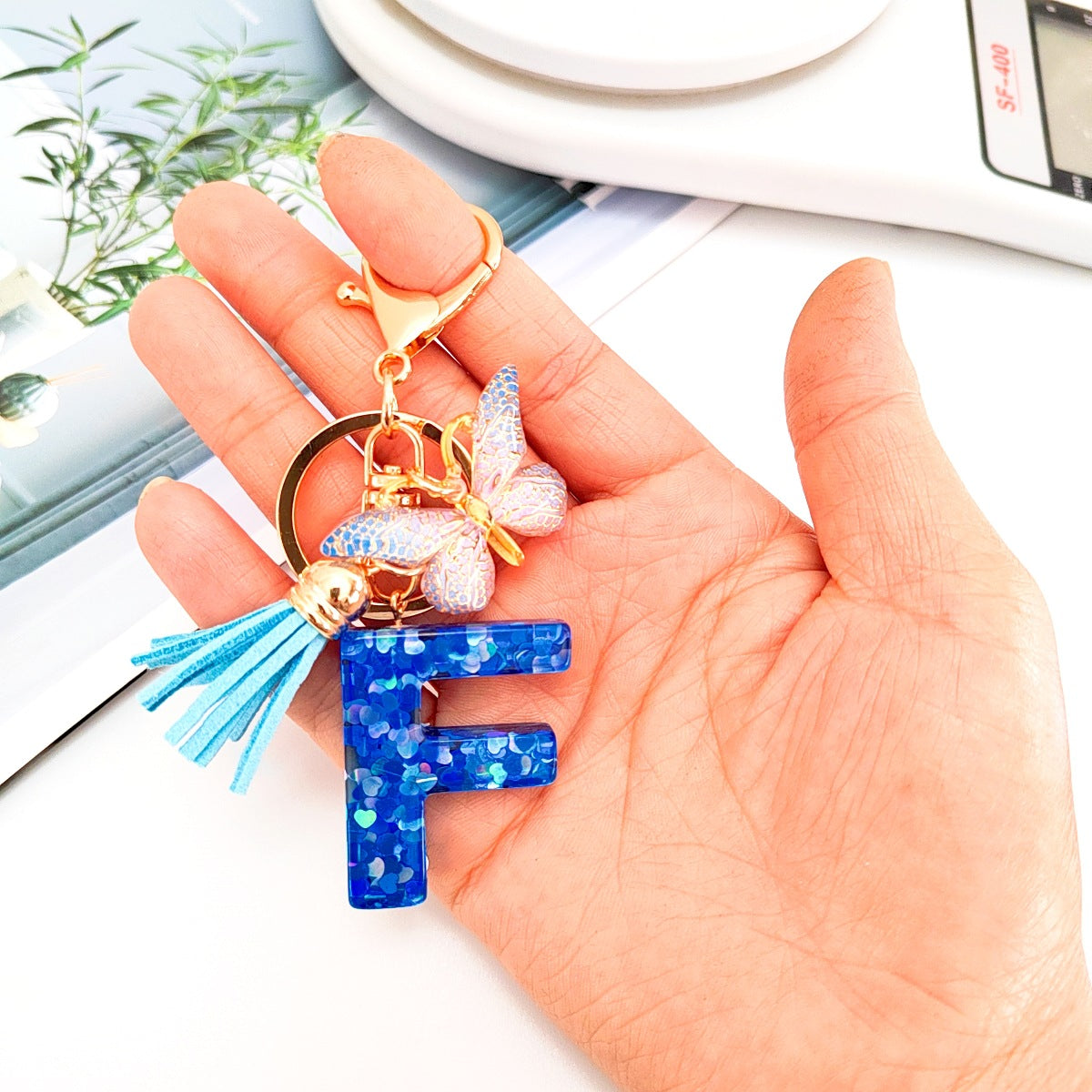 Wholesale blue crystal epoxy letter key chain pendant resin sequined butterfly key chain