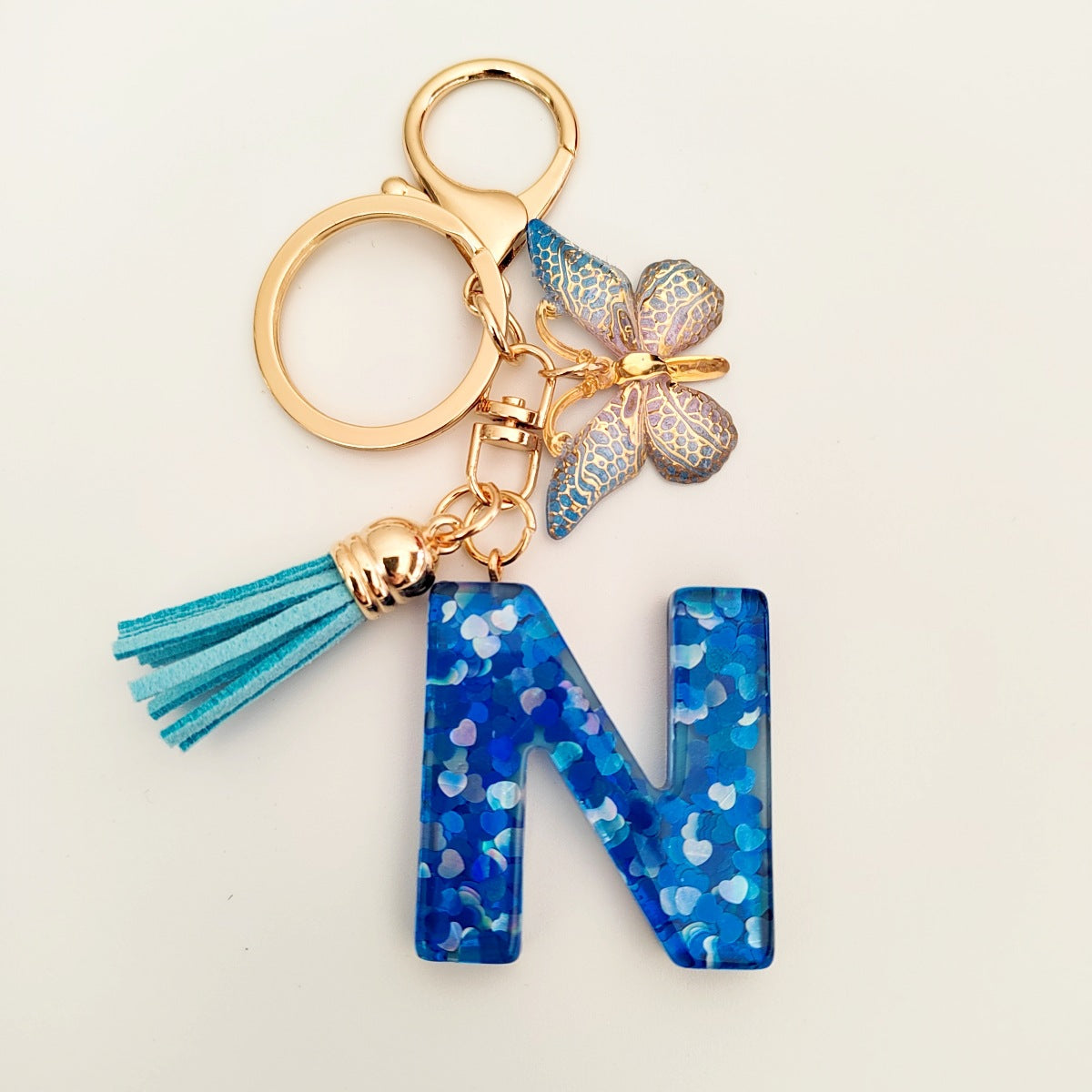 Wholesale blue crystal epoxy letter key chain pendant resin sequined butterfly key chain