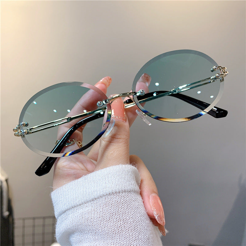 Wholesale Women's oval gradient frameless trimmed sunglasses