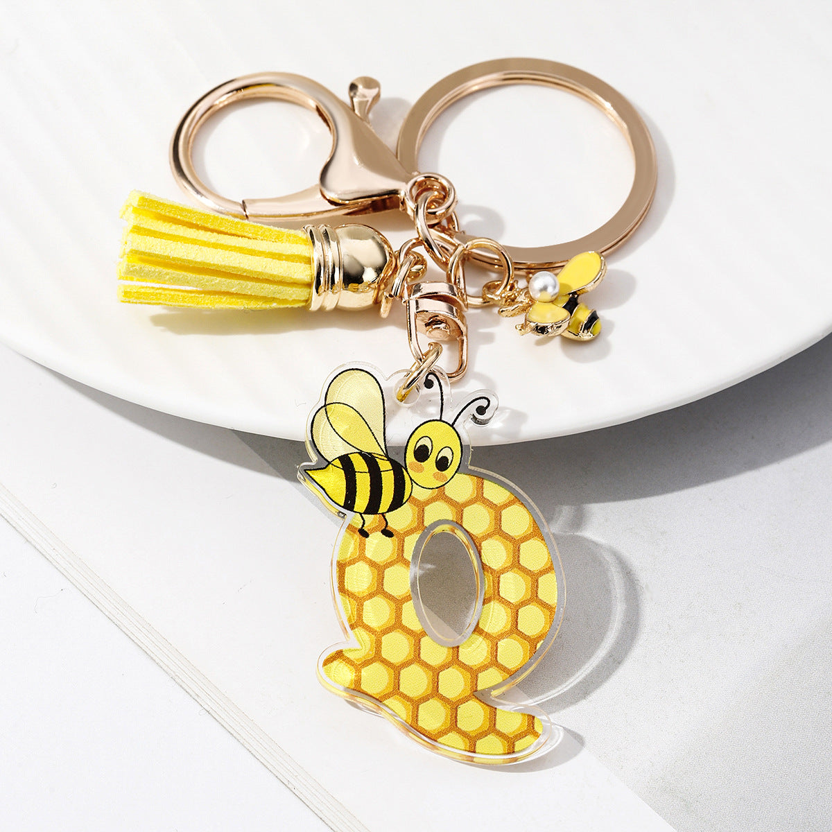 Wholesale Bee Honeycomb Acrylic English Letter Tassel Bee Enamel Keychain