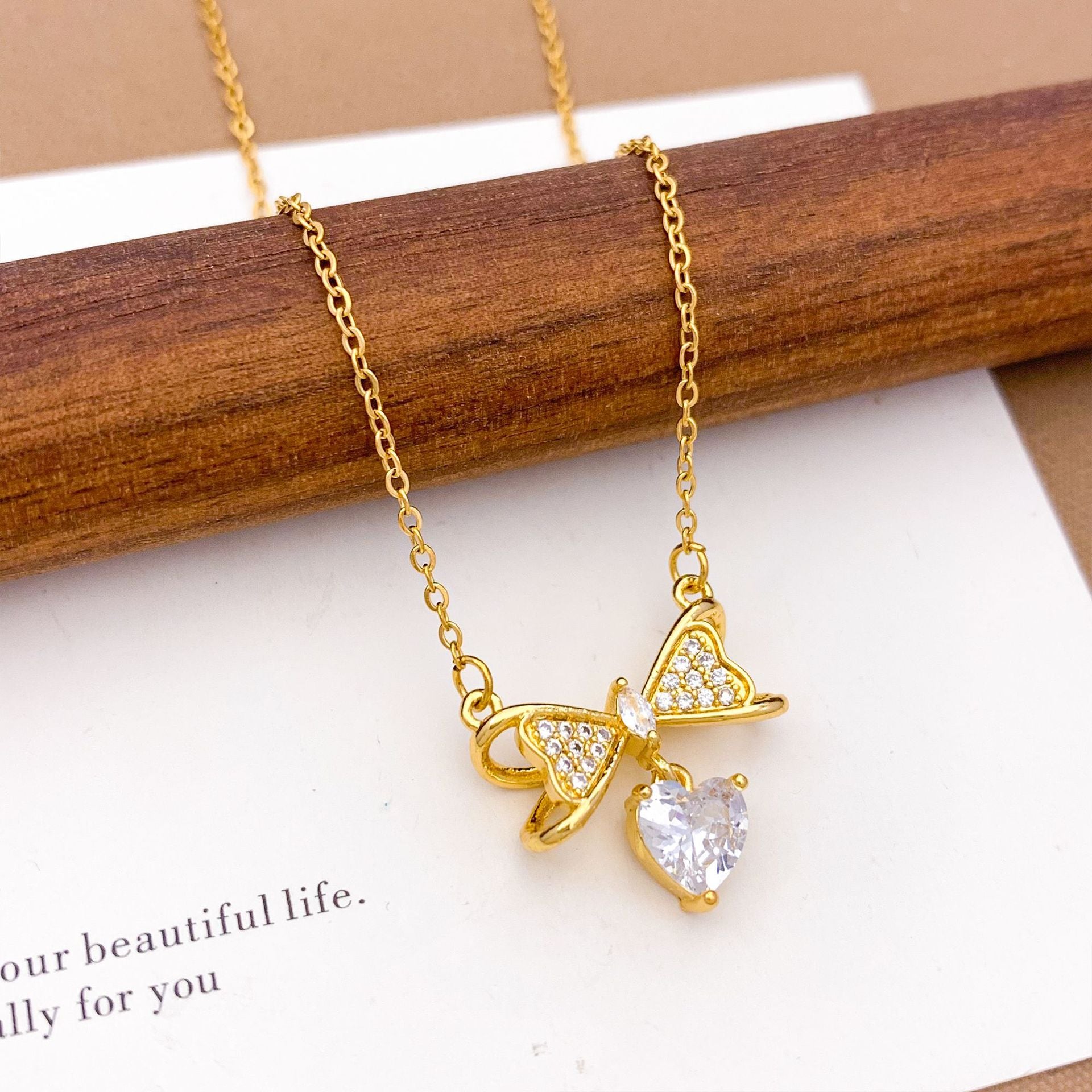 Wholesale Pink heart-shaped bow with diamond studded titanium steel necklace