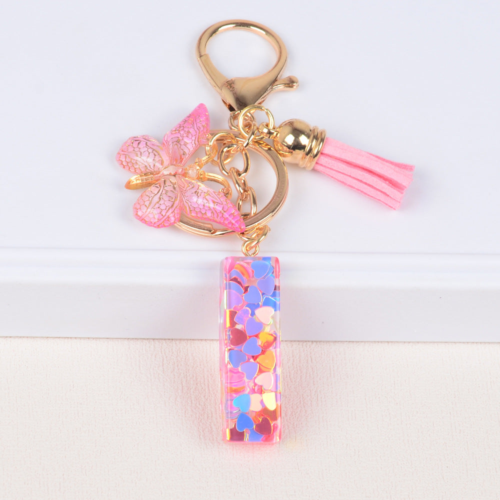 卸売ピンクタッセルバタフライグリッターレター樹脂キーホルダー