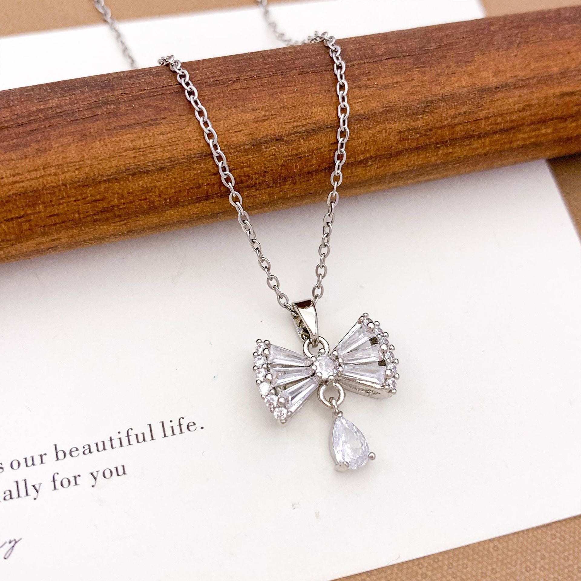 Wholesale Pink heart-shaped bow with diamond studded titanium steel necklace