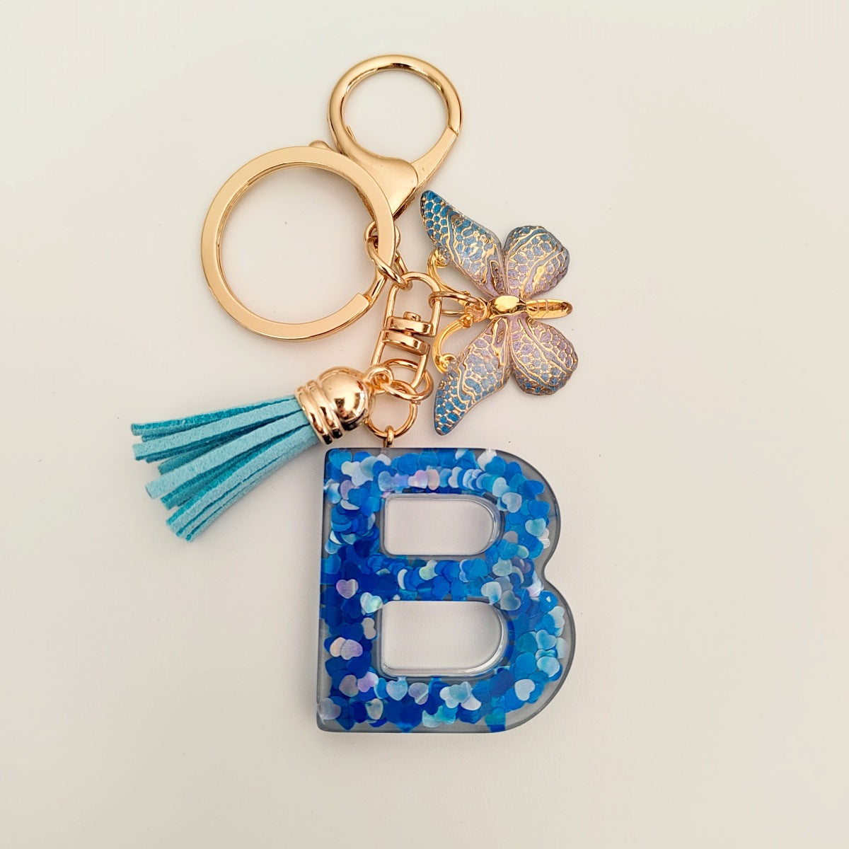 Wholesale blue crystal epoxy letter key chain pendant resin sequined butterfly key chain