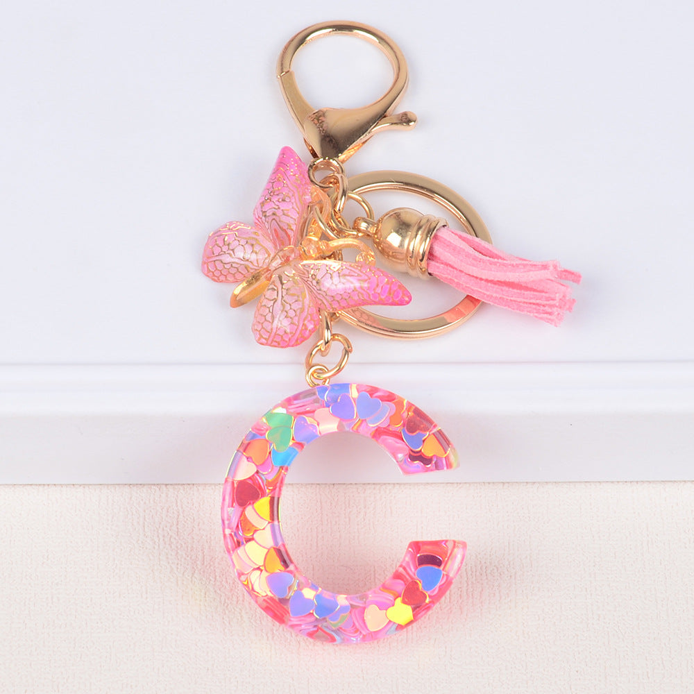 卸売ピンクタッセルバタフライグリッターレター樹脂キーホルダー