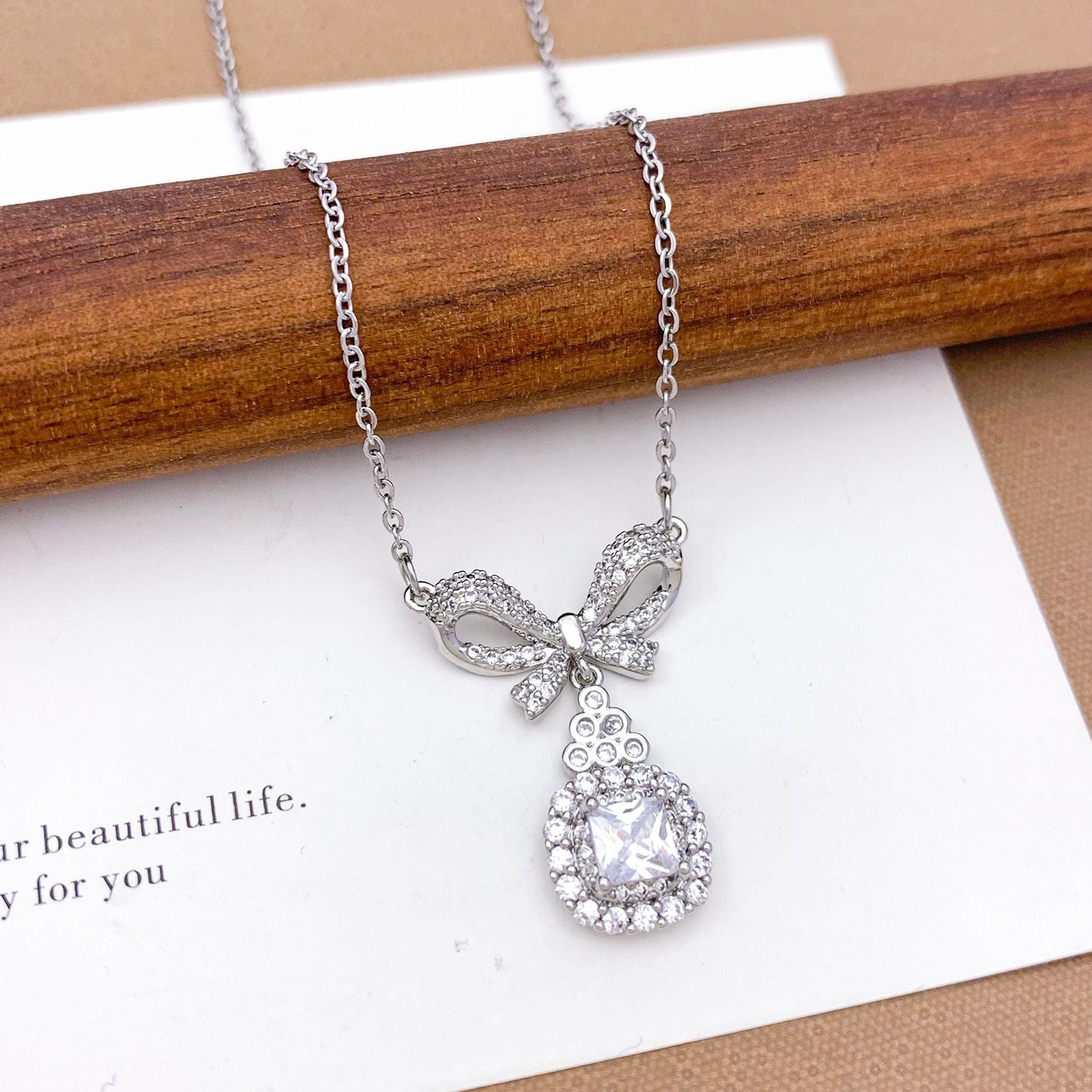 Wholesale Pink heart-shaped bow with diamond studded titanium steel necklace