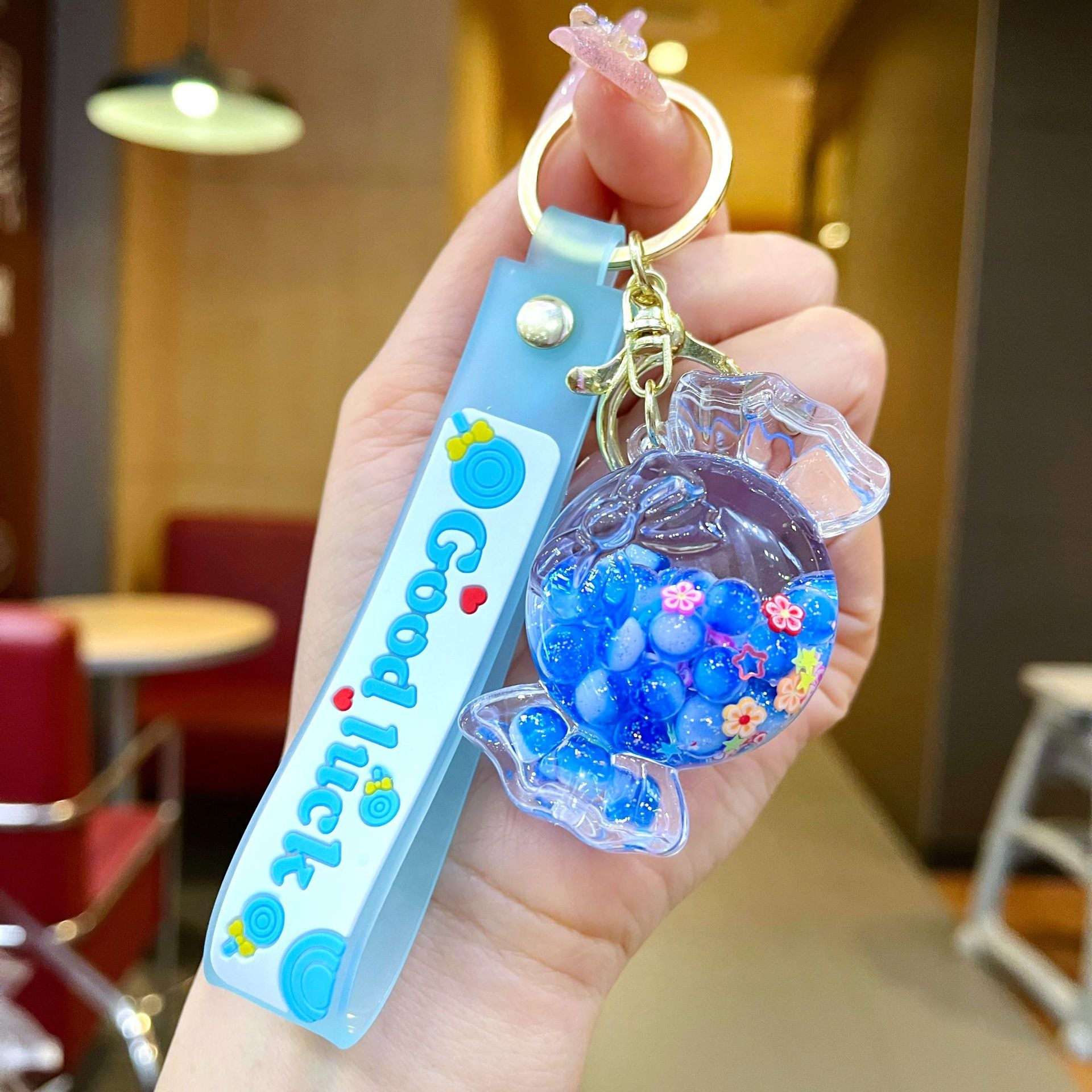 Wholesale Oil filled luminous colorful candy quicksand bottle keychain