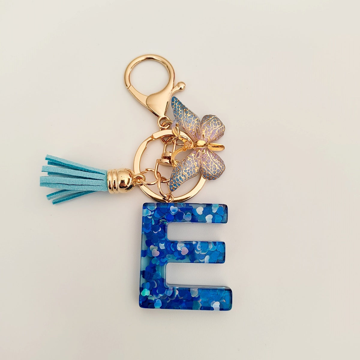 Wholesale blue crystal epoxy letter key chain pendant resin sequined butterfly key chain