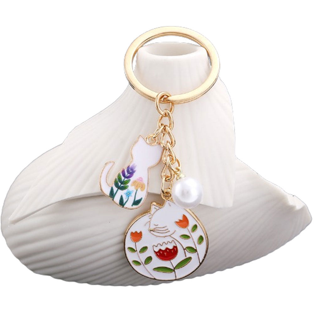 Wholesale oil drop cartoon cute flowers white cat pearl keychain metal jewelry pendant manufacturers