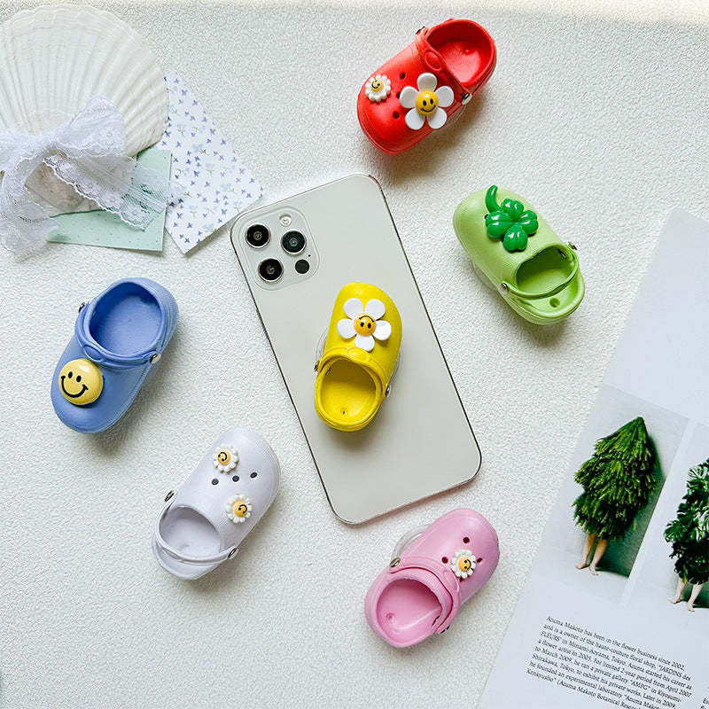 Zapatillas de cara sonrientes al por mayor soporte de airbag de teléfono móvil de plástico