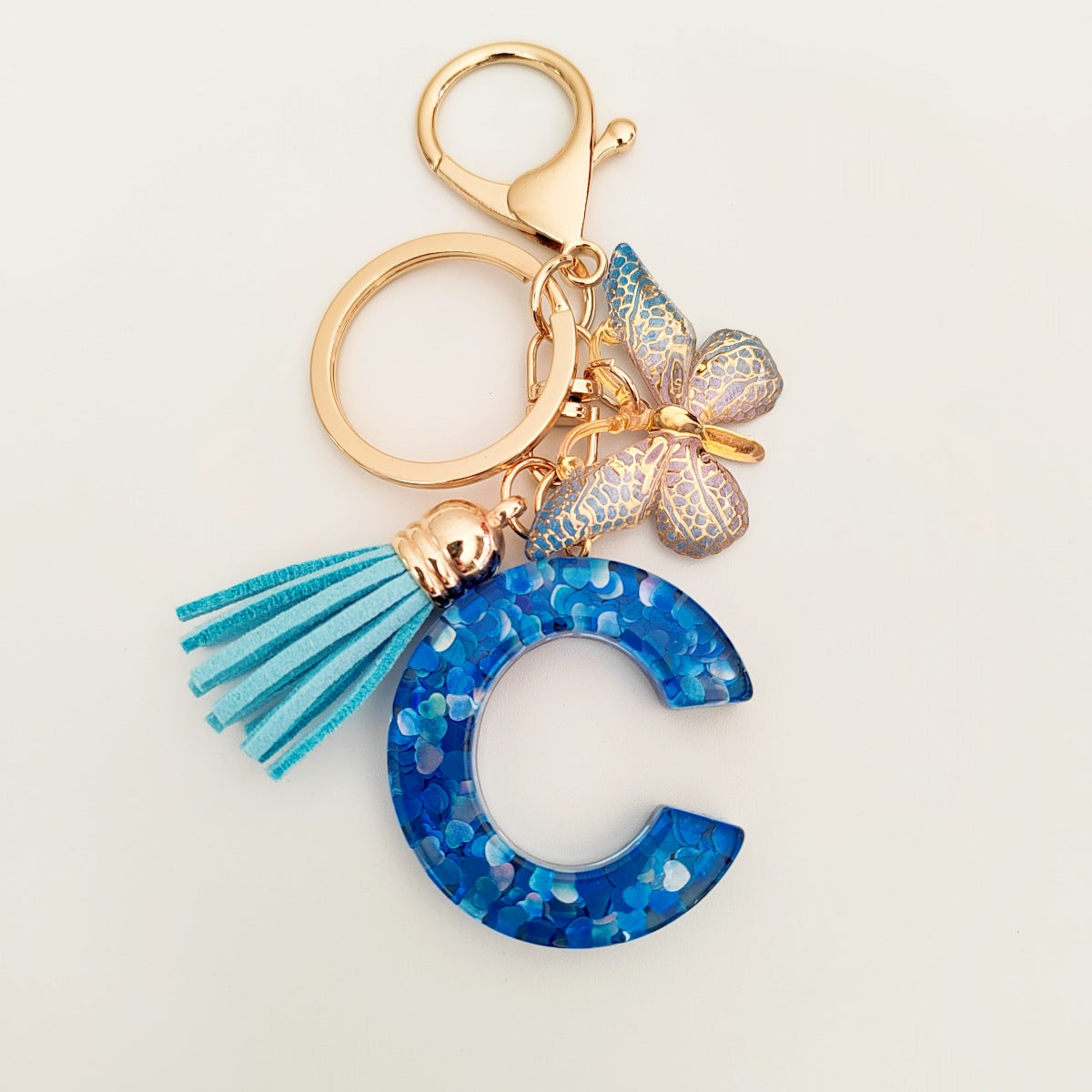 Wholesale blue crystal epoxy letter key chain pendant resin sequined butterfly key chain