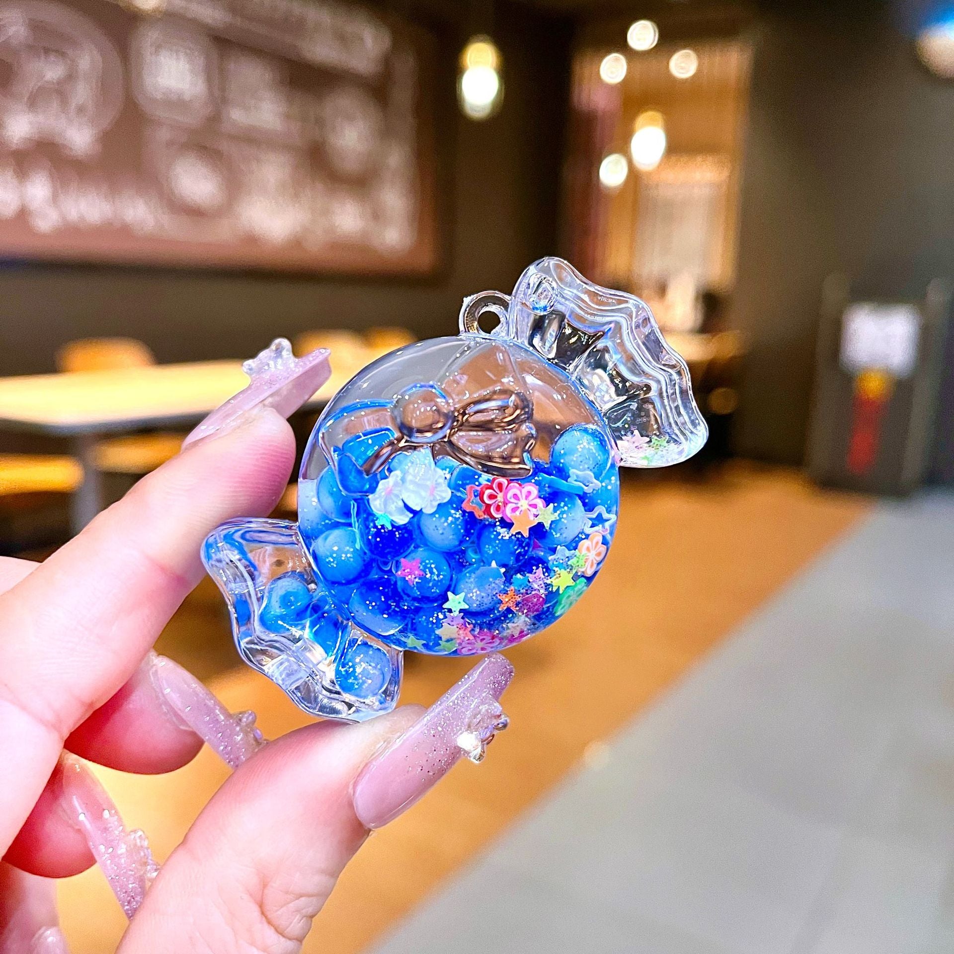 Wholesale Oil filled luminous colorful candy quicksand bottle keychain