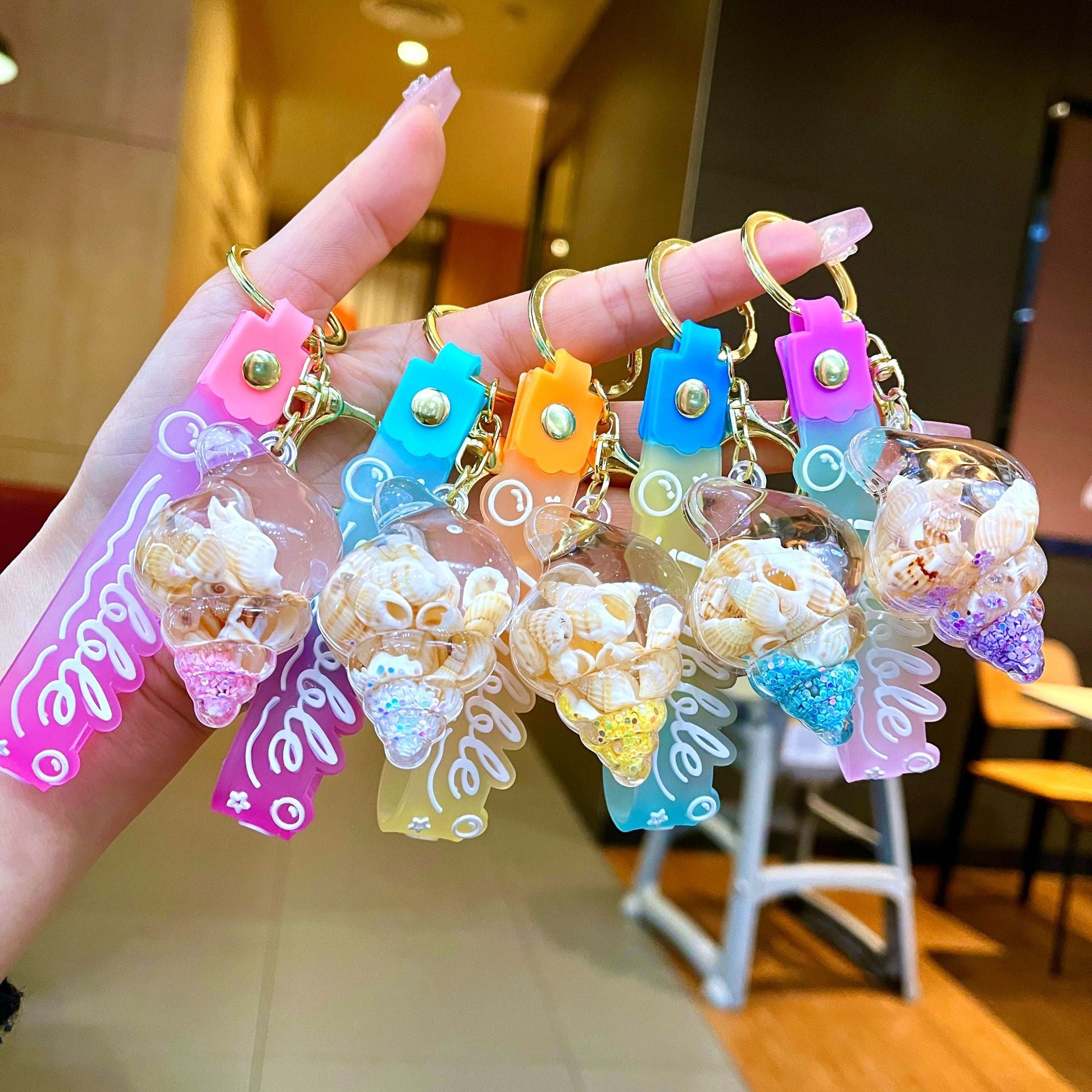 Wholesale Colorful flowing sand seashell DIY insert oil keychain