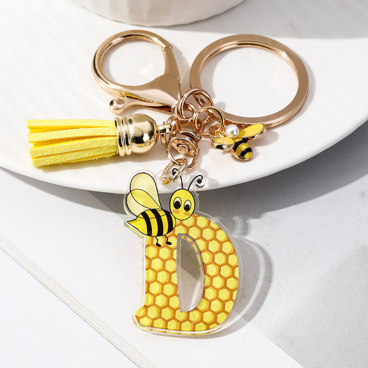 Wholesale Bee Honeycomb Acrylic English Letter Tassel Bee Enamel Keychain