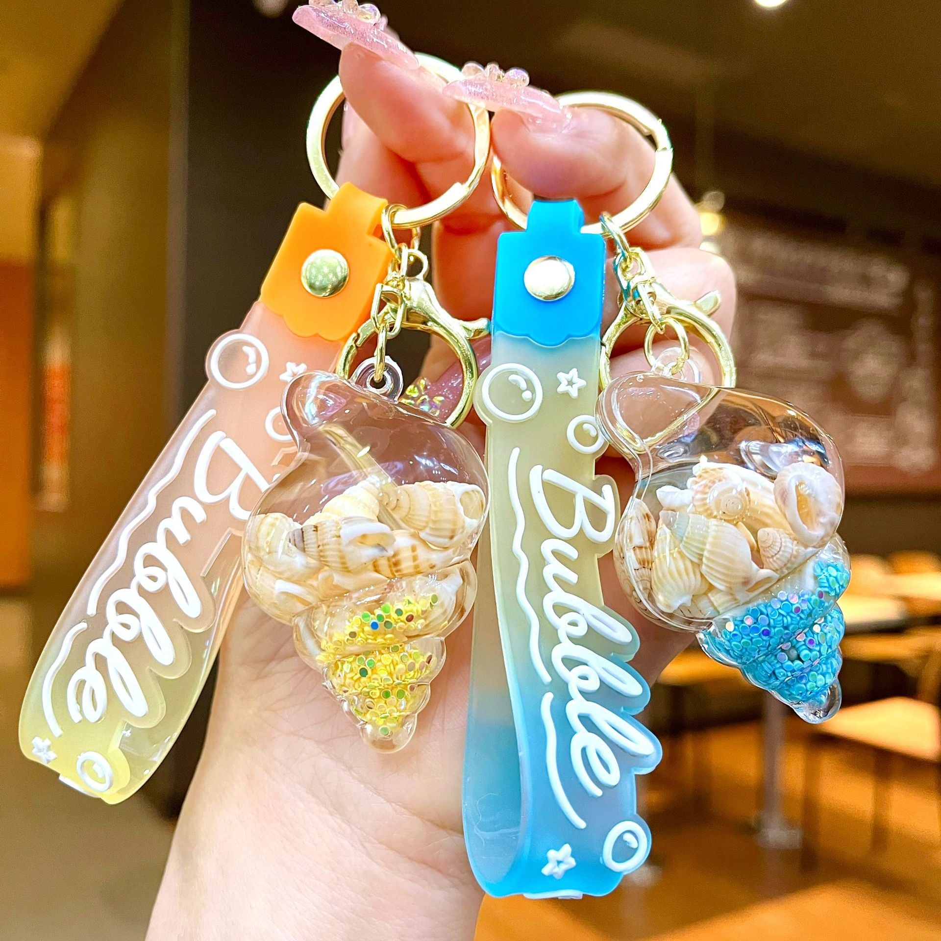 Wholesale Colorful flowing sand seashell DIY insert oil keychain