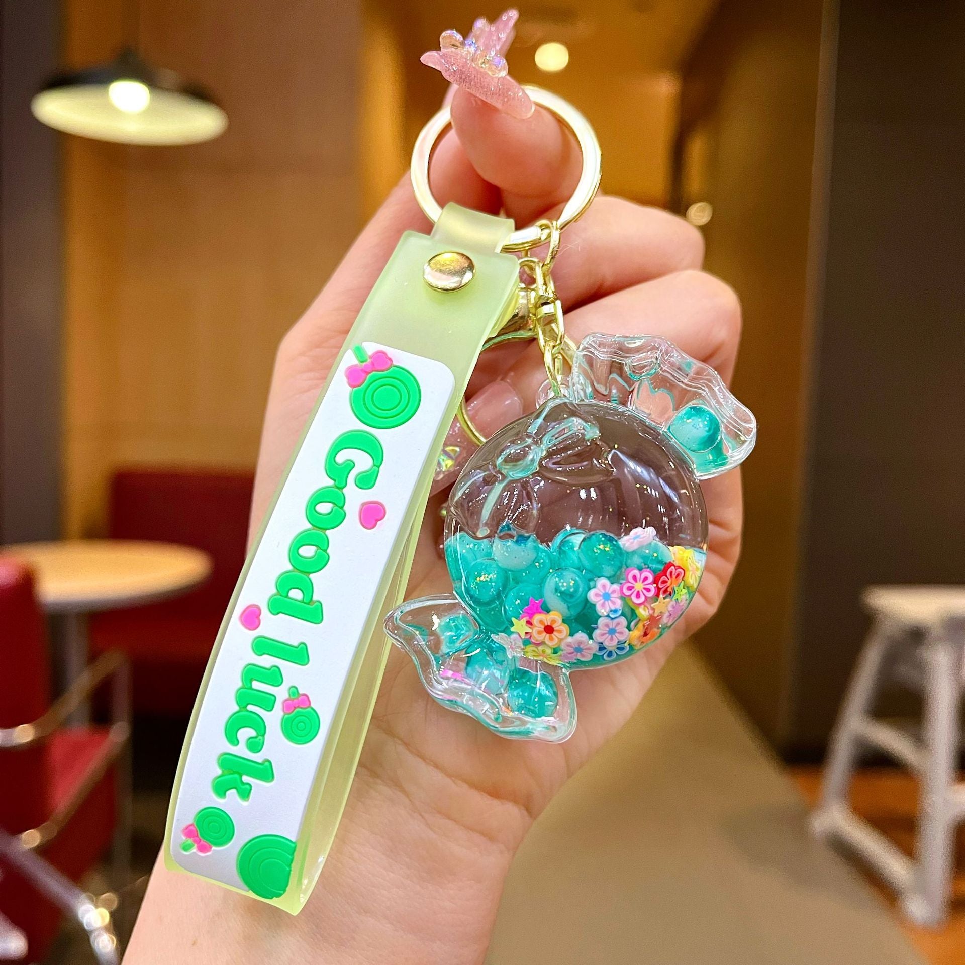 Wholesale Oil filled luminous colorful candy quicksand bottle keychain